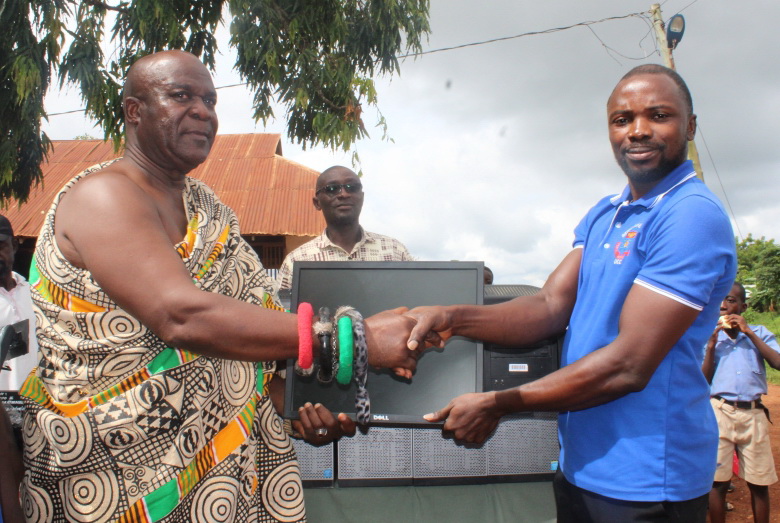 Nana Kwesi Addo II (left), Akyem Kotoku Mponua Gyasehene of Pankese handing over the desktop computers to Mr Charles Appiah-Kubi (right), the headmaster of Pankese Roman Catholic Junior High School.
